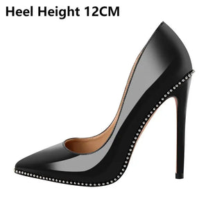 Black high-heeled shoe with studded details on a white background