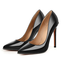 Load image into Gallery viewer, Black high-heeled shoes with studded details on a white background
