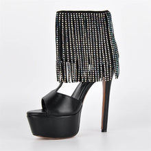 Load image into Gallery viewer, Black high-heeled shoe with a platform and embellished ankle strap on a white background