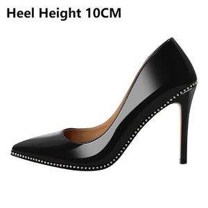 Black high-heeled shoe with studded details on a white background, heel height indicated as 10CM.