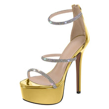 Load image into Gallery viewer, Gold high-heeled sandal with rhinestone straps on a white background