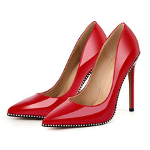 Load image into Gallery viewer, Red high-heeled shoes with studded details on a white background