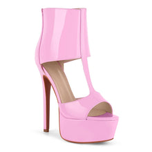 Load image into Gallery viewer, A single high-heeled platform ankle boot in glossy light pink patent leather, featuring a cutout T-strap design and a high stiletto heel, shown against a plain white background.