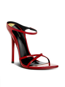 Red high-heeled sandal with thin straps on a white background