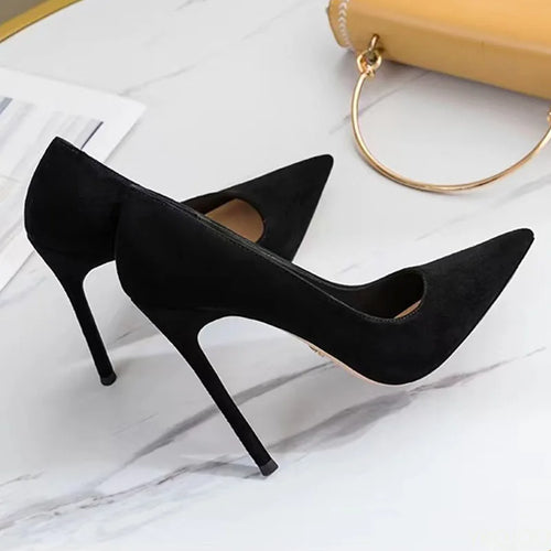 Black high-heeled shoes on a light background