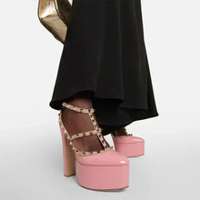 Load image into Gallery viewer, Pink platform shoes with studded details worn with a black skirt on a light gray background