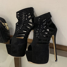 Load image into Gallery viewer, Black high-heeled shoes with cut-out design on a white surface.