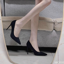 Load image into Gallery viewer, Black high-heeled shoes worn with beige pants in a mirror reflection.