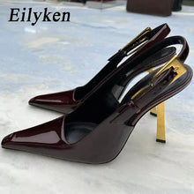 Load image into Gallery viewer, Pair of high-heeled shoes with gold accents on a light background, branded &#39;Eilyken&#39;.