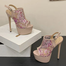 Load image into Gallery viewer, Pair of high-heeled shoes with floral design on a black surface.