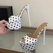 Load image into Gallery viewer, Polka dot high-heeled shoes with a hand holding one shoe.