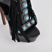 Load image into Gallery viewer, Black high-heeled shoe with turquoise embellishments and fringes on a light gray background