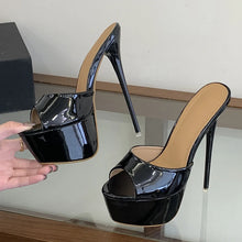 Load image into Gallery viewer, Black high-heeled shoe with a platform on a glass surface.