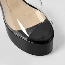 Load image into Gallery viewer, Black high-heeled shoe with a clear protective film on a light gray background