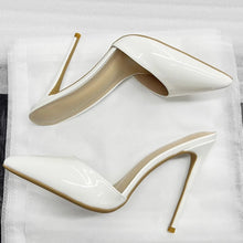Load image into Gallery viewer, A pair of glossy white patent leather high-heeled mule pumps with stiletto heels and open toes, displayed on a white textured fabric background.