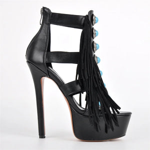 Black high-heeled sandal with fringe details on a white background