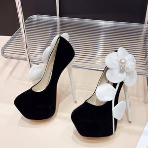 Side view high heel with white flower.