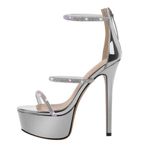 Load image into Gallery viewer, Silver high-heeled platform shoe with rhinestone straps on a white background