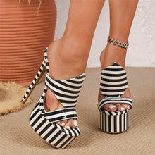 Load image into Gallery viewer, A pair of women's platform high heels with black and white striped fabric straps, shown on a model's feet against a neutral textured background.