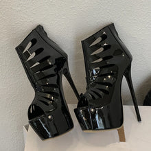 Load image into Gallery viewer, Black high-heeled shoes with cut-out design on a white surface.