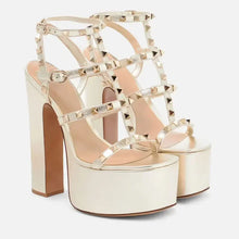 Load image into Gallery viewer, Gold platform high heels with studded details on a white background
