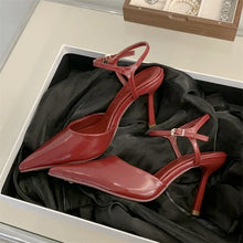 Load image into Gallery viewer, Red high-heeled shoes in an open box with a black interior.