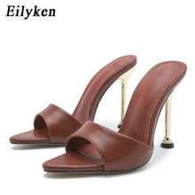 Load image into Gallery viewer, Brown high-heeled sandals with gold heels on a white background, branded 'Eilyken'.