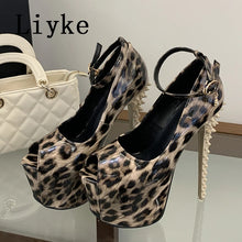 Load image into Gallery viewer, Leopard print high-heeled platform shoes with studded heels and ankle straps, displayed on a glass surface next to a white quilted handbag. The brand name 'Liyke' is visible in the top left corner.