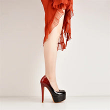 Load image into Gallery viewer, Black high-heeled shoes worn with a red dress on a light background