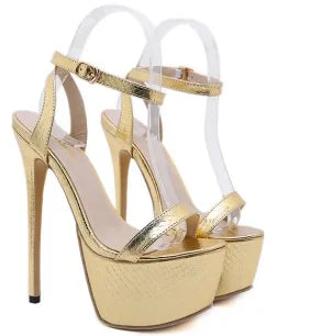 Gold high-heeled platform sandals on a white background