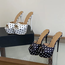 Load image into Gallery viewer, Black and white polka dot high-heeled shoes on a reflective surface with a neutral background
