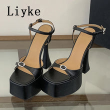 Load image into Gallery viewer, Black high-heeled sandals with platform sole on a reflective surface, brand 'Liyke' visible.