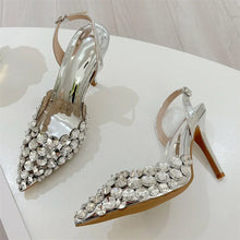 Load image into Gallery viewer, Silver high-heeled shoes with crystal embellishments on a white surface.