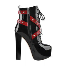 Load image into Gallery viewer, Black high-heeled boot with red straps on a white background