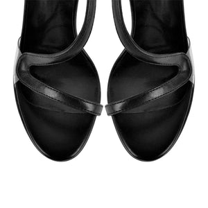 Pair of black high-heeled sandals on a white background