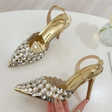 Load image into Gallery viewer, Gold high-heeled shoes with crystal embellishments on a white surface.