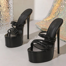 Load image into Gallery viewer, Black high-heeled platform sandals on a reflective surface with a glittery background