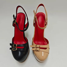 Load image into Gallery viewer, Pair of red and black high-heeled shoes with gold buckles on a light gray background