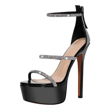 Load image into Gallery viewer, Black high-heeled sandal with glittery straps on a white background