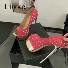 Load image into Gallery viewer, Pink high-heeled shoes with gold studs on a black surface, brand &#39;Liyke&#39; visible.