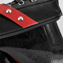 Load image into Gallery viewer, Black bag with red strap and silver studs on a gray background