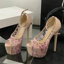 Load image into Gallery viewer, Pair of high-heeled shoes with floral design on a reflective surface.