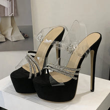 Load image into Gallery viewer, Black high-heeled sandals with clear straps on a white surface