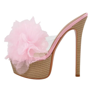 High-heeled shoe with a pink flower on a white background