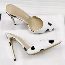 Load image into Gallery viewer, A pair of glossy white pointed-toe mule high heels with black polka dots and slim metallic gold stiletto heels, displayed on a white surface.