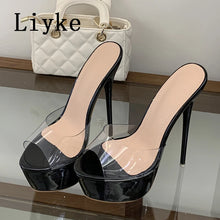 Load image into Gallery viewer, A pair of black high-heeled mule sandals with clear transparent platform and toe straps, displayed on a glass shelf with a white quilted handbag in the background. The brand name 'Liyeke' is printed in black text in the upper left corner.