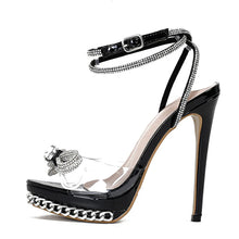 Load image into Gallery viewer, Black high-heeled sandal with clear platform and chain details on a white background