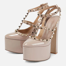 Load image into Gallery viewer, Beige high-heeled platform shoes with studded details on a white background
