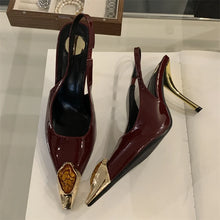 Load image into Gallery viewer, Pair of high-heeled shoes with gold accents on a white surface