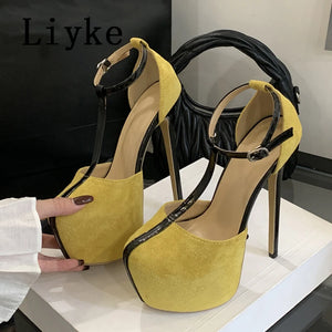Yellow high-heeled shoes with black straps held by a person, brand 'Liyke' visible.
